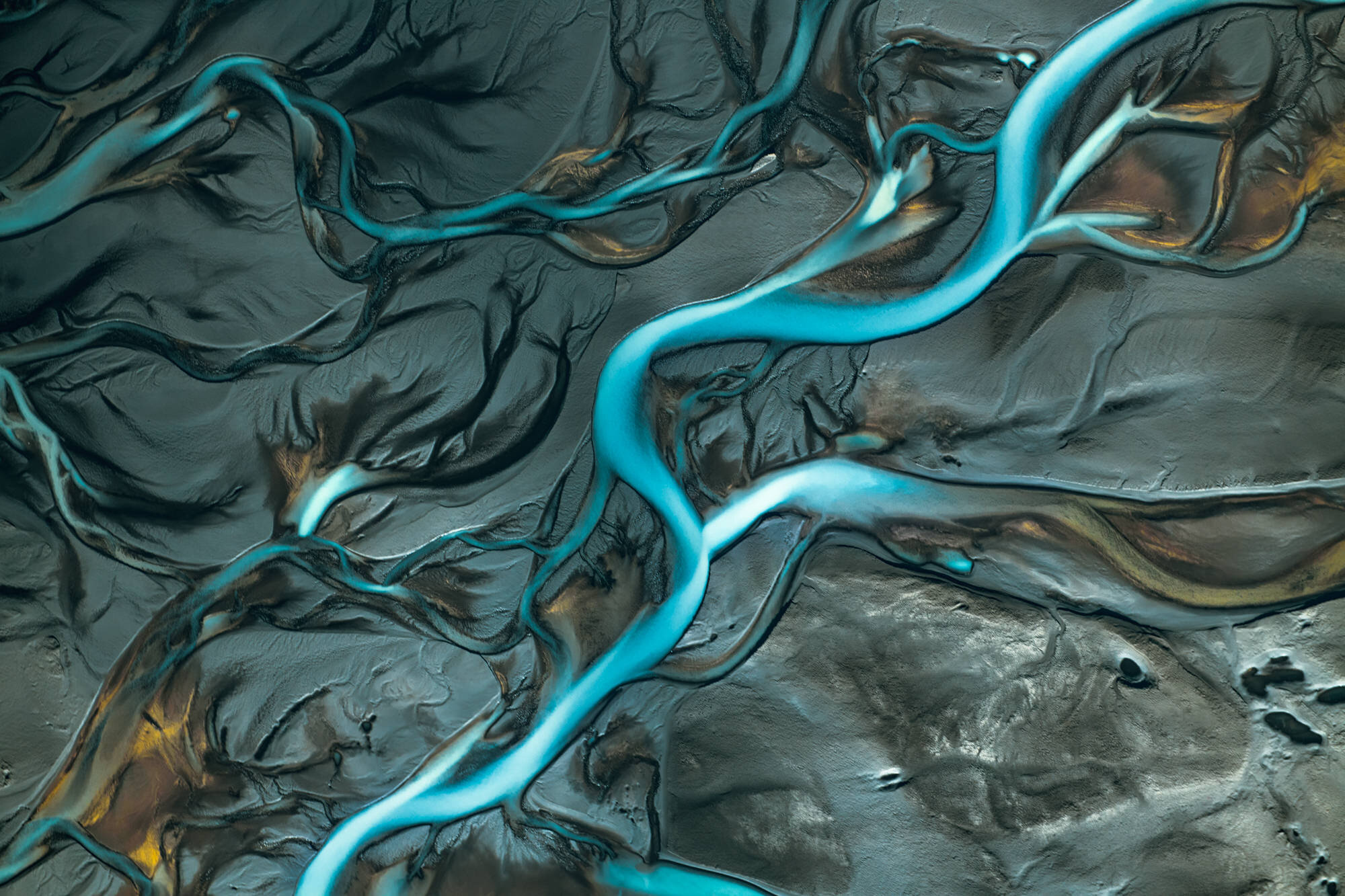 Aerial view of a blue glacier river in Iceland - photographed by Chris Byrne. | Photo Title: Blue Ribbons | 
        Photo by Chris Byrne ©2023