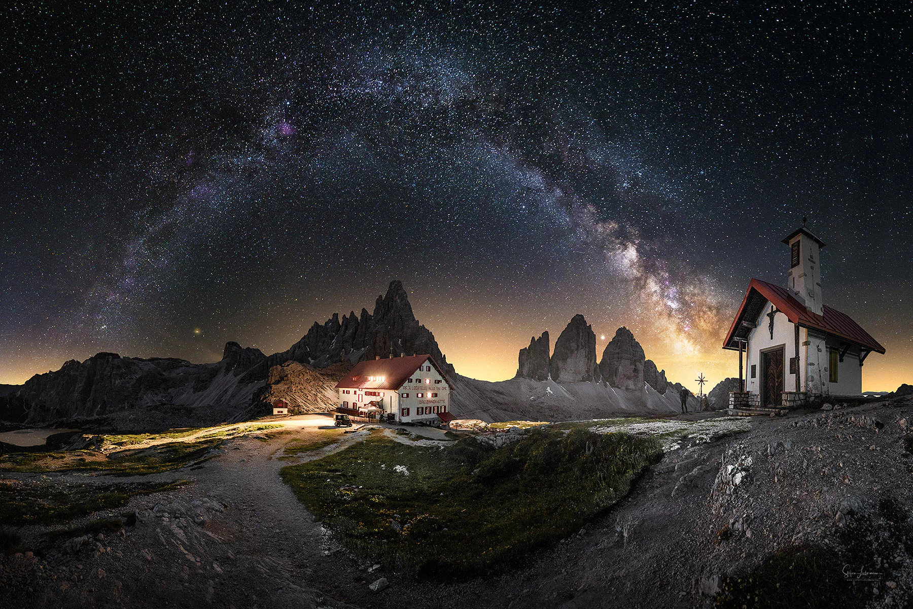 Milky Way over Three Peaks Church and Tre Cime di Lavaredo (Three Peaks of Lavaredo) in the Dolomites, Italy | Photo Title: Three Peaks Church | 
        Photo by Steffi Liebermann ©2023